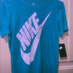 a woman’s blue nike t-shirt...